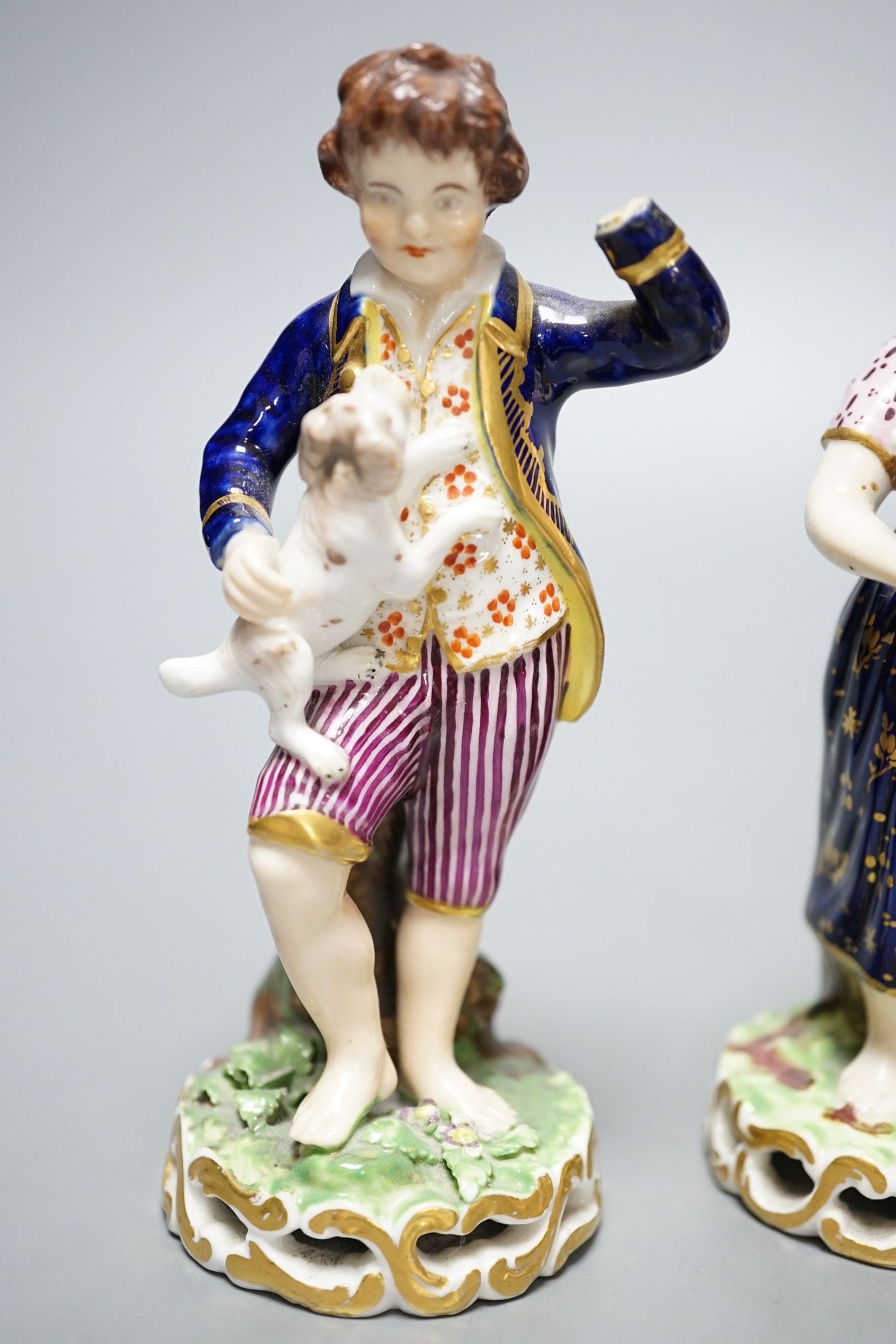 A Minton porcelain figure of a lady seated with a dog c.1830, a pair of Derby figures of a girl and a boy with a dog and a sheep, and a Bloor Derby vase